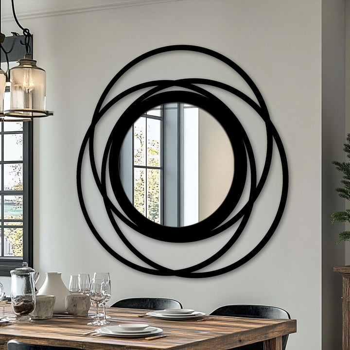 Black is the dominant color in this intertwined ring circle floor mirror, a striking piece of metal artwork with a bold, modern design.