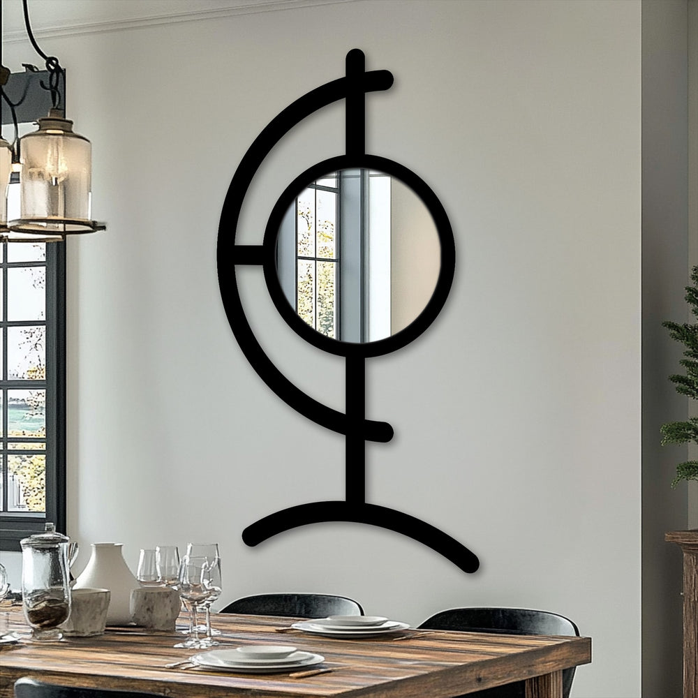 Warm color temperatures highlight the sculptural black metal artwork surrounding the round center mirror in the Orbit Line floor mirror.
