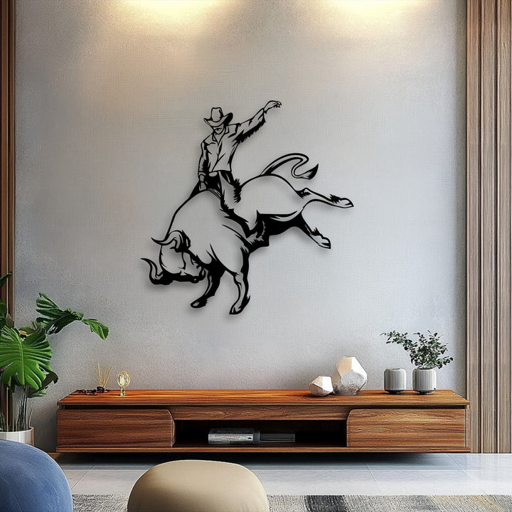 The warm color temperature highlights the striking cowboy bull riding metal art for wall, creating a dynamic rodeo scene.