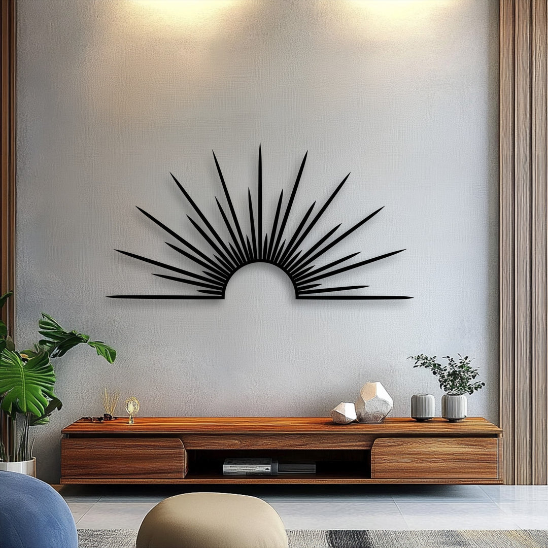 Softly textured white wall beautifully highlights the bold, unique metal wall art featuring a minimal black sunburst with radiant lines.