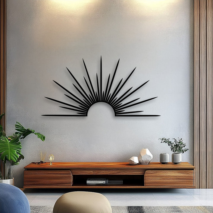 Softly textured white wall beautifully highlights the bold, unique metal wall art featuring a minimal black sunburst with radiant lines.