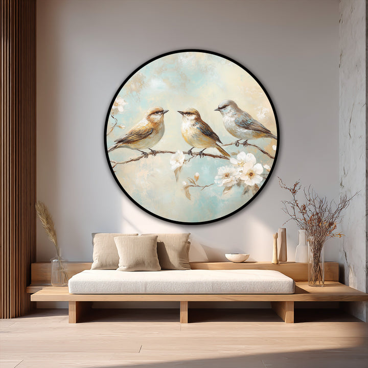Loudest element is the circular oil painting decoration featuring three songbirds perched on a blossoming branch, creating a peaceful and eye-catching display.