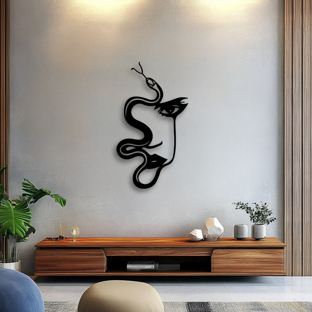 Minimal color saturation highlights the dramatic contrast of this abstract woman and serpent decorative metal art on a subtly textured wall.