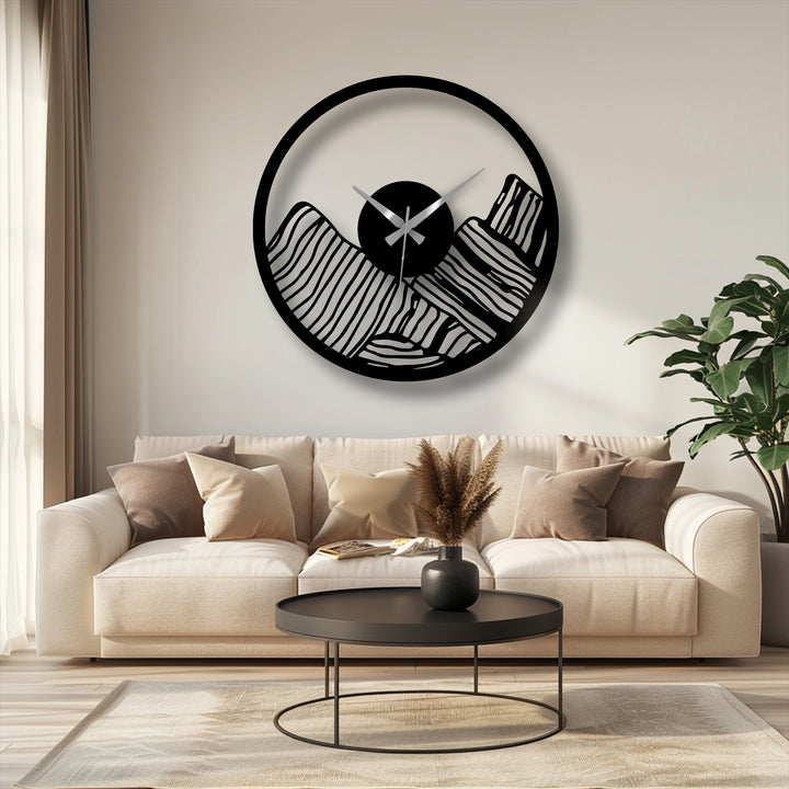Negative space highlights the modern canyon landscape in this decorative metal art wall clock, where the mountain range design creates a striking contrast.