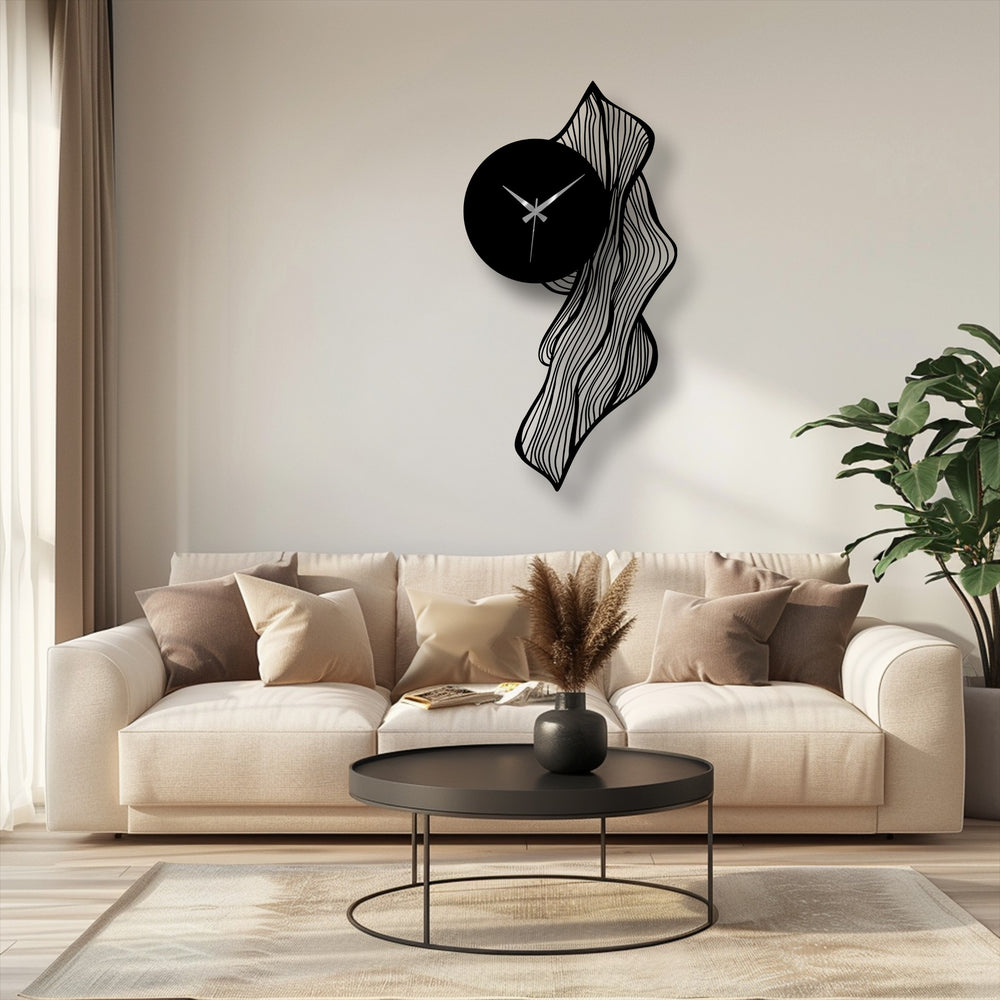 Foreground shows the textured rug below a sleek coffee table that enhances the view of the flowing abstract leaf metal wall clock, an example of unique metal wall art.
