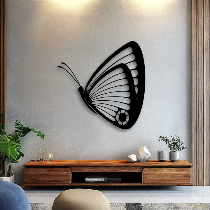The brightly illuminated textured wall highlights the intricate black butterfly metal art for wall.