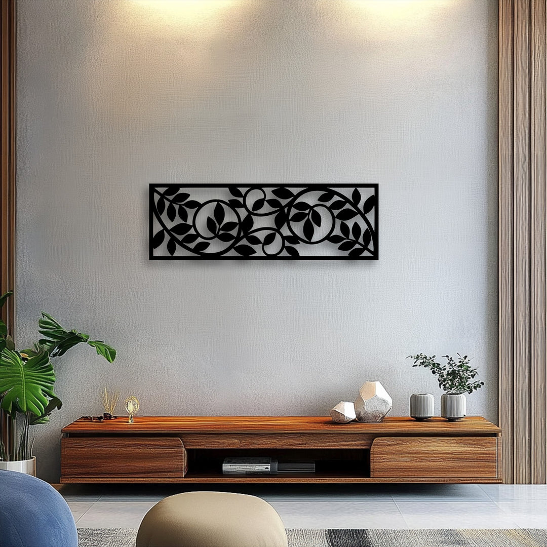 The brightest area illuminates the textured wall above a captivating flowing botanical vine pattern metal art for wall, enhancing its modern appeal.