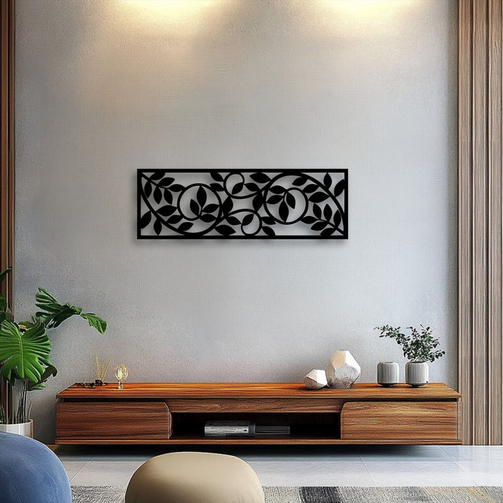 The brightest area illuminates the textured wall above a captivating flowing botanical vine pattern metal art for wall, enhancing its modern appeal.