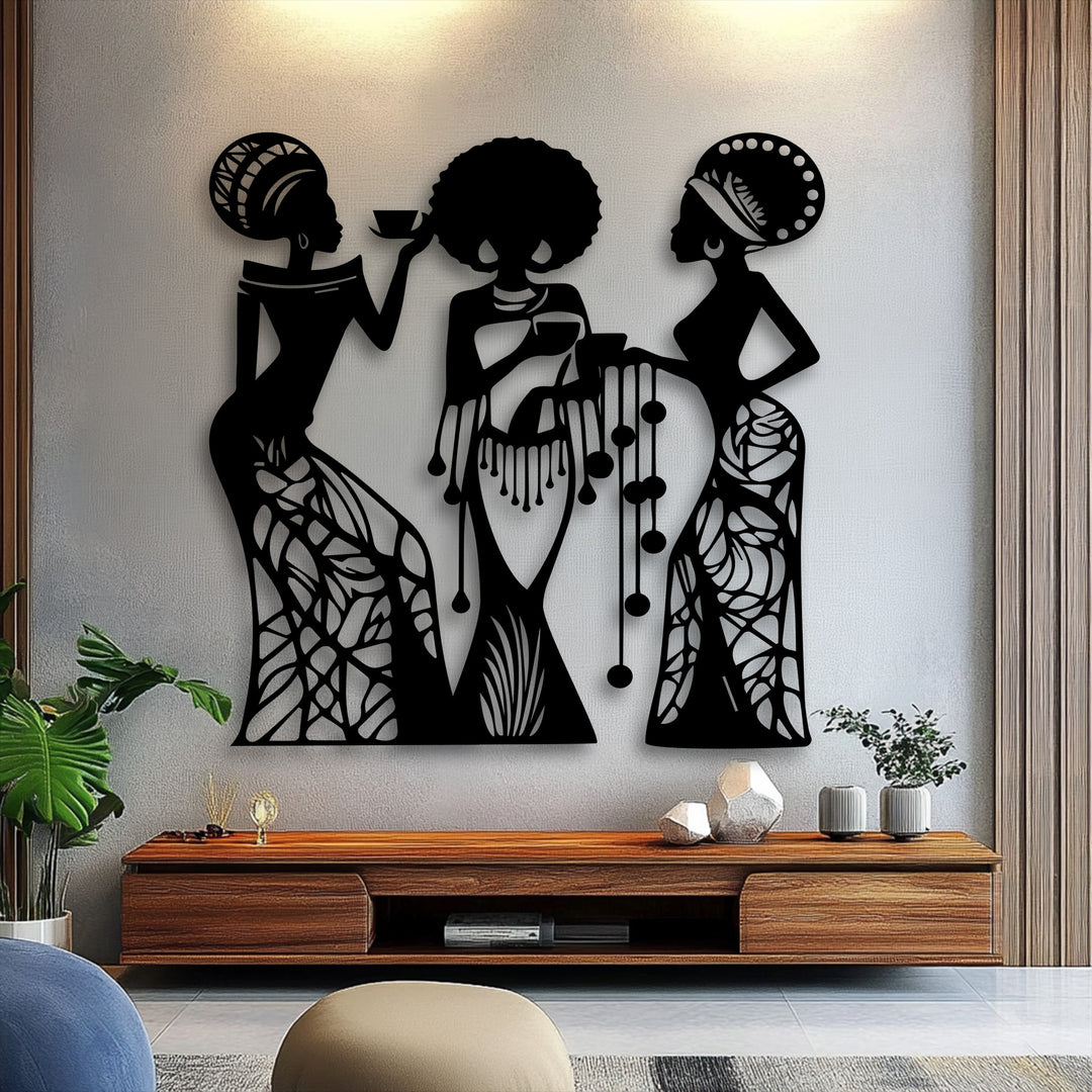 Three elegant African women silhouettes, a captivating metal art for wall piece, featuring intricate headdresses and patterned dresses.