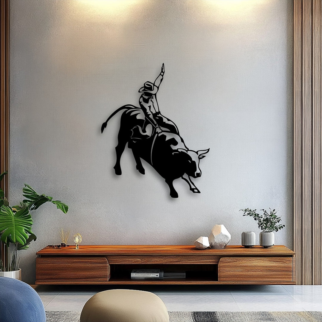 The visual rhythm of the bucking bull and rodeo cowboy metal artwork dynamically captures western action.