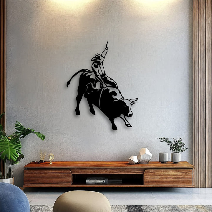 The visual rhythm of the bucking bull and rodeo cowboy metal artwork dynamically captures western action.