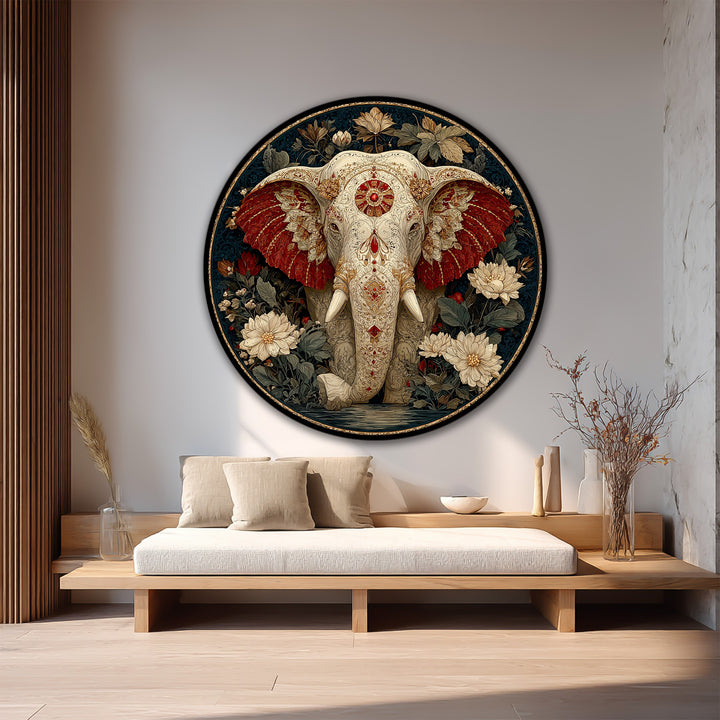 Softly textured pillows rest beneath a captivating sacred elephant, an ornamental round oil painting art prints with crimson ears and intricate floral details on wood.
