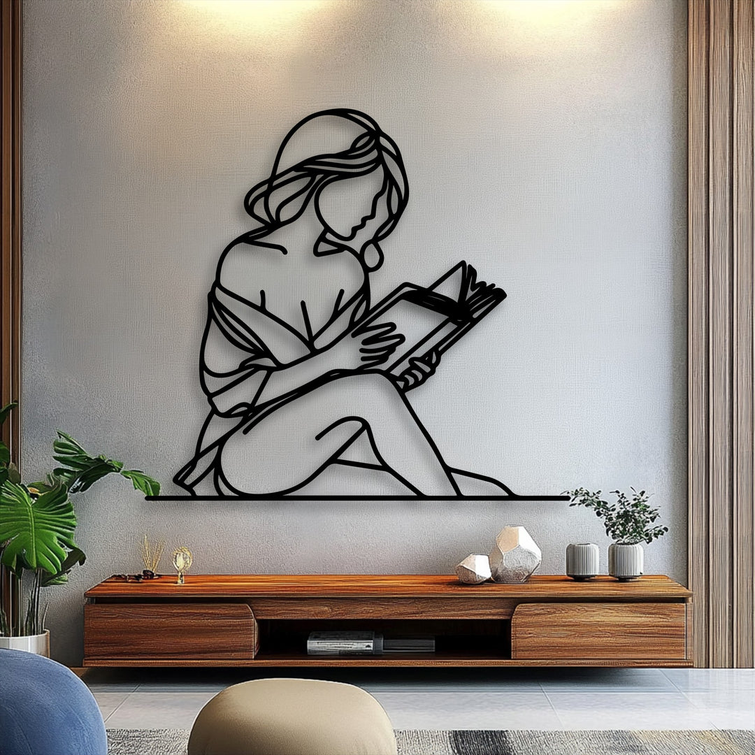 The crisp, linear geometric elements form a beautiful silhouette of a woman reading, creating a piece of unique metal wall art.