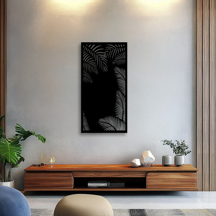 The visual rhythm of overlapping tropical palm leaf silhouettes creates a captivating unique metal wall art piece above a wooden console.