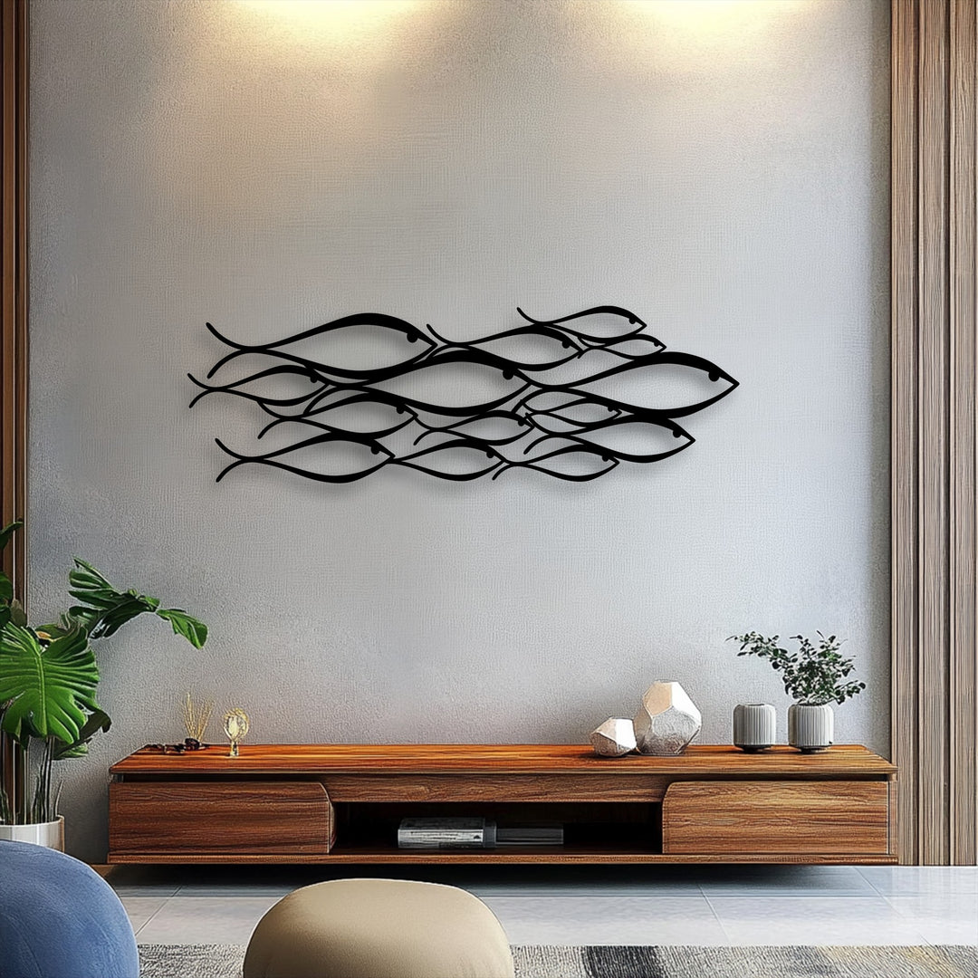 The minimalist school of fish decorative metal art masterfully shapes the surrounding negative space on the subtly textured wall.