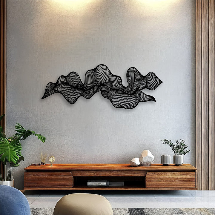 The brightest area of the textured wall highlights the intricate, flowing lines of the modern abstract wave metal decoration wall art.