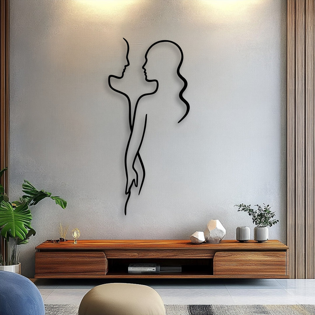 The realistic detail in this unique metal wall art highlights a black minimal couple line silhouette, casting shadows on the textured grey wall.
