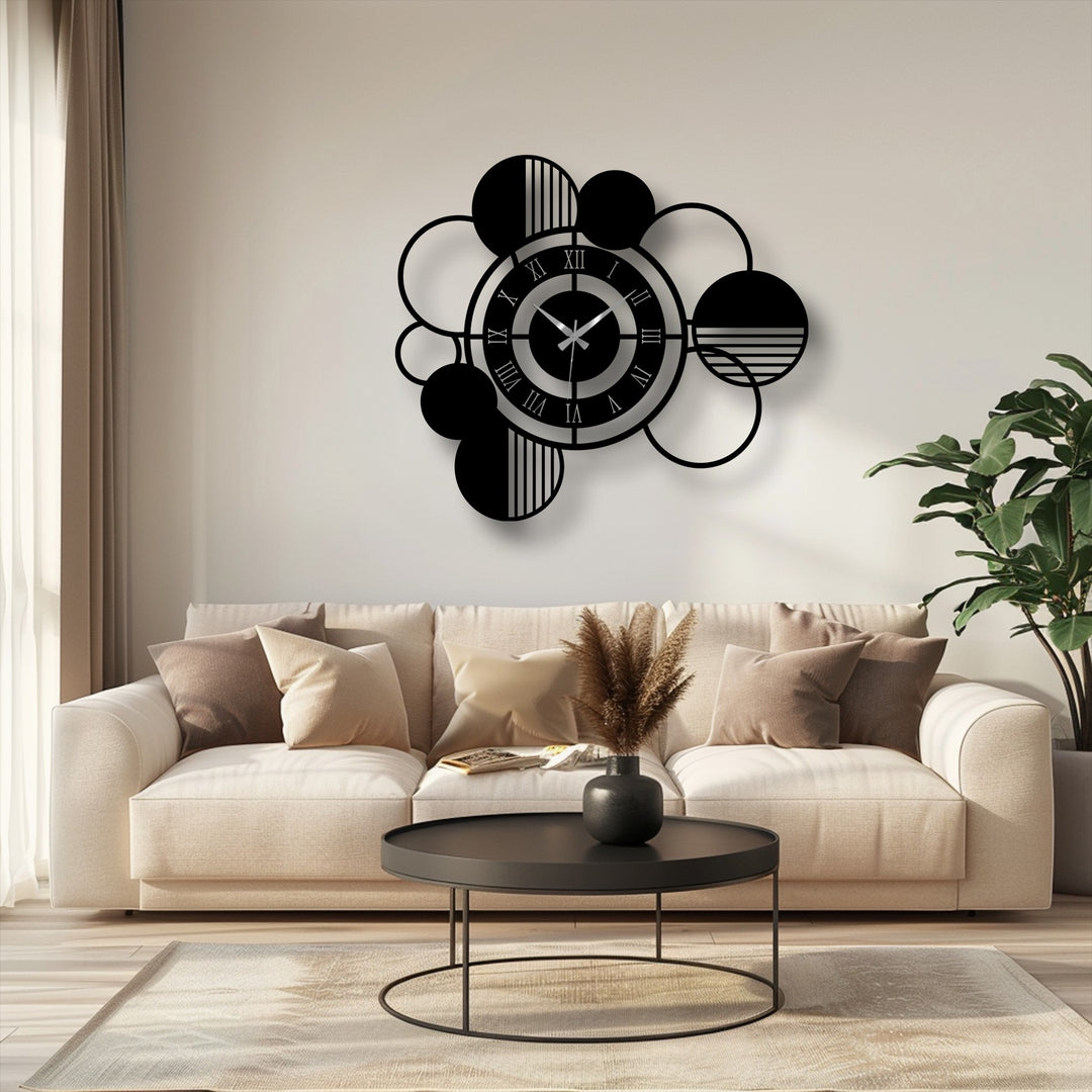 Interlocking circles and spheres create organic forms in this modern abstract metal artwork wall clock, offering geometric interest to any room.