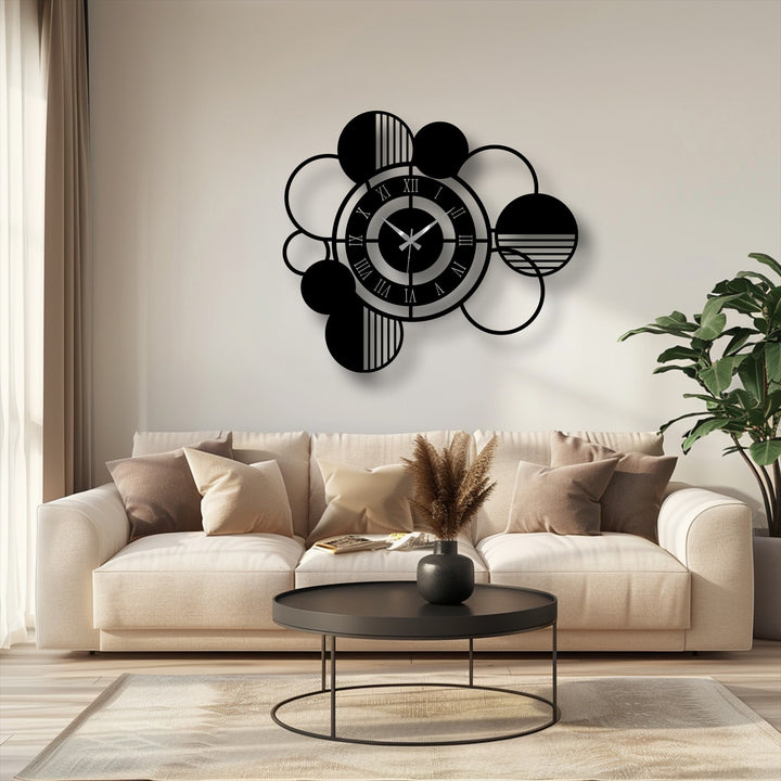 Interlocking circles and spheres create organic forms in this modern abstract metal artwork wall clock, offering geometric interest to any room.