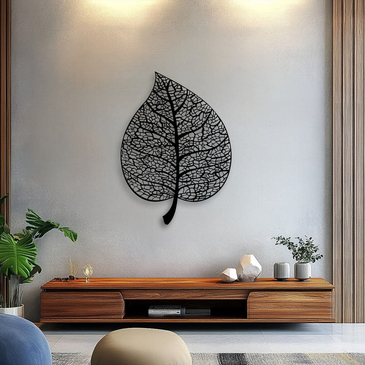 The striking, intricate botanical leaf silhouette, a piece of metal decoration wall art, showcases its delicate vein pattern on a textured wall.