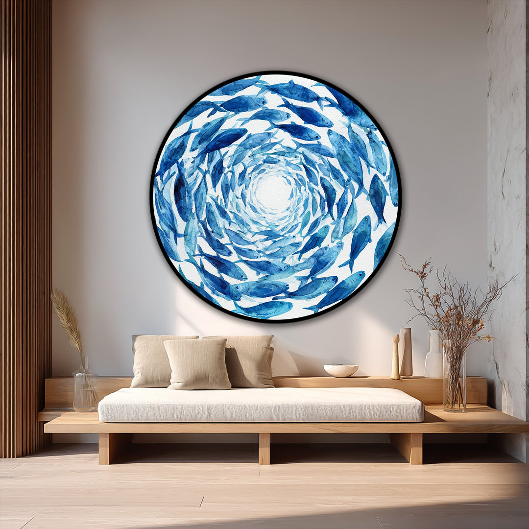 Vibrant blue spiral school of fish in a round oil painting makes a bold and captivating statement as a piece of modern oil painting art mounted above a neutral-toned daybed.