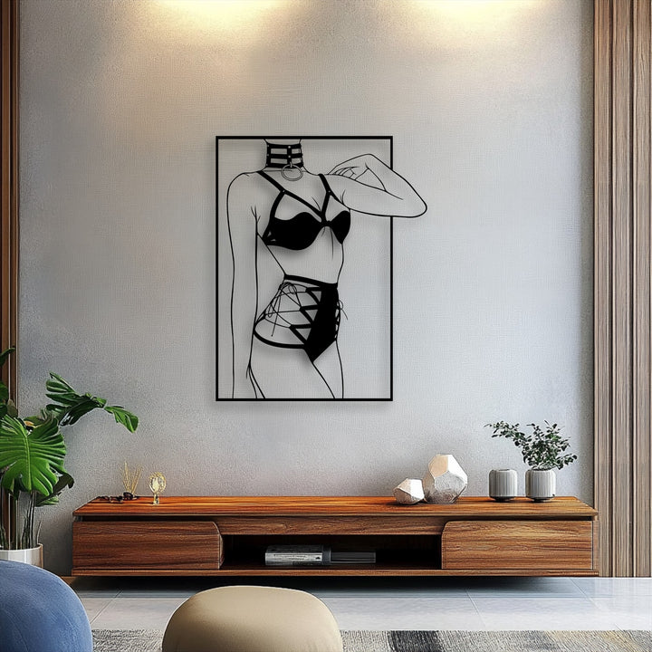 The focal point is a striking black minimalist female silhouette in lingerie, a decorative metal art piece, centered above a wooden console.