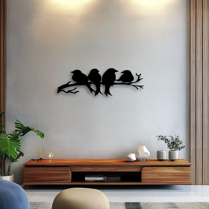 The matte black finish of the decorative metal art creates a striking silhouette of birds perched serenely on a branch.