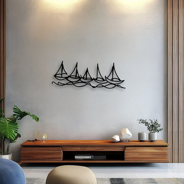 The gently textured, neutral-toned wall provides a serene backdrop for the striking minimal sailboat metal artwork featuring five sleek boats on undulating ripples.