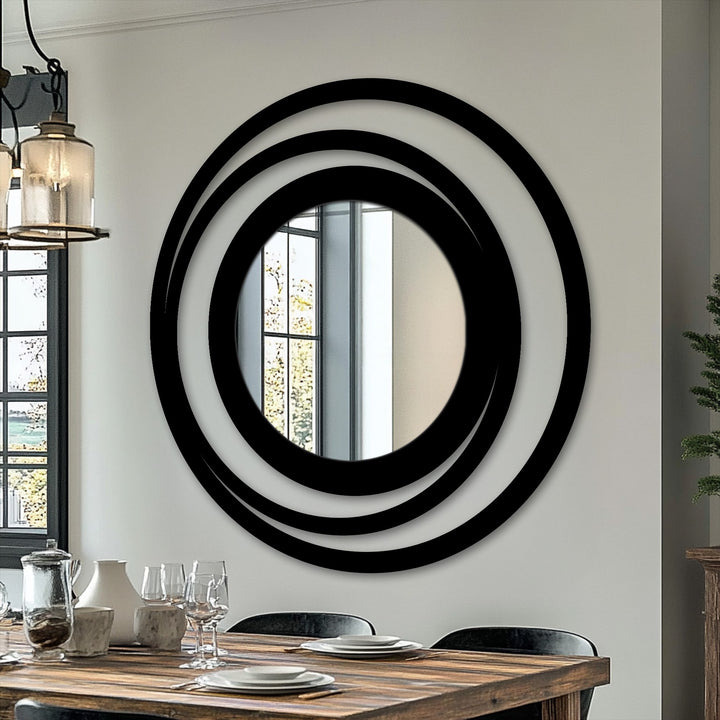 Horizontally oriented, the circular modern mirror features an eye-catching orbit ring design with black-layered circles as a frame.