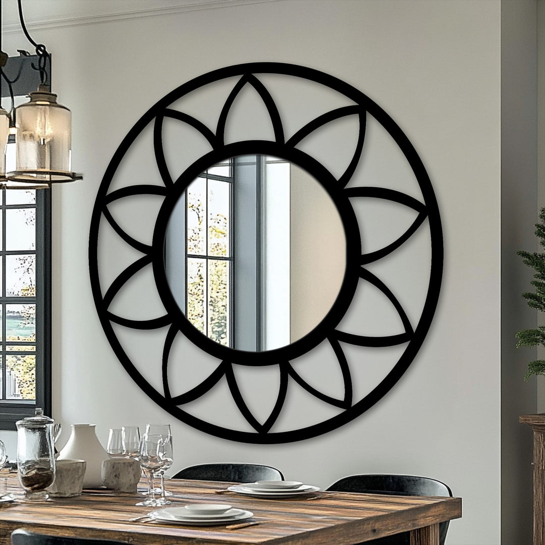 Negative space highlights the intricate petal design surrounding this round framed wall mirror, creating a captivating and modern focal point.