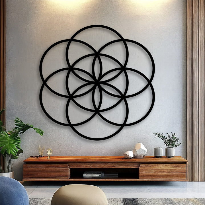 The distinct, clean edges and borders of the black Flower of Life geometric metal wall decor create a compelling shadow effect.