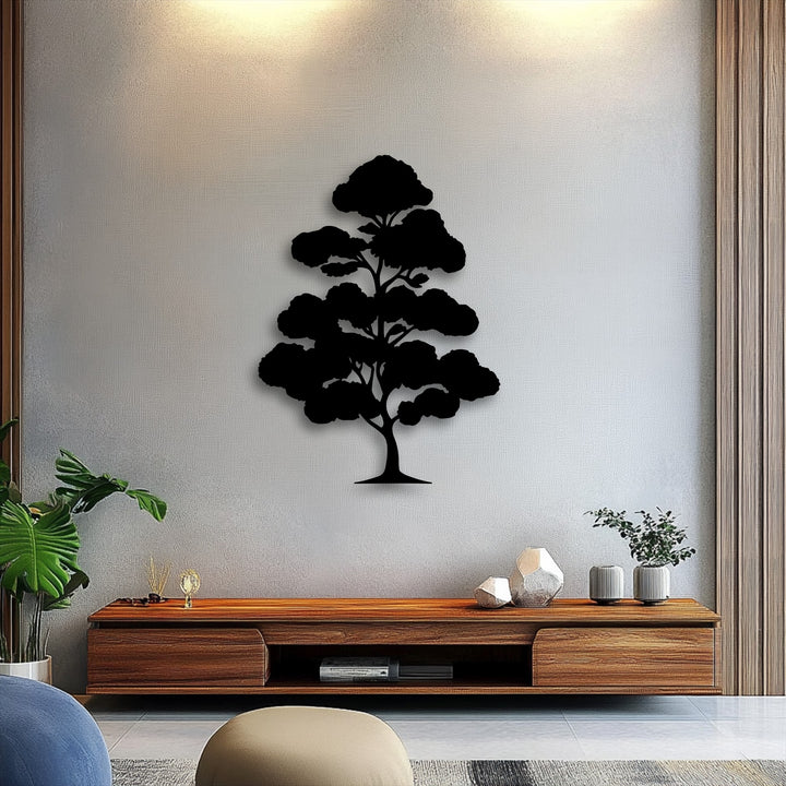 The image features subdued color saturation, highlighting the elegant black bonsai tree decoration wall art against a textured light gray wall.