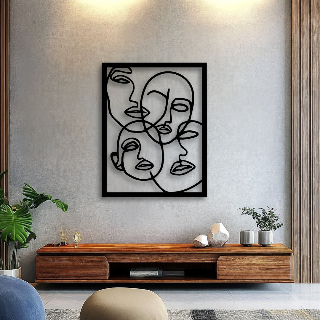 Surface textures are evident on the subtly stippled wall, contrasting with the smooth, matte finish of the abstract faces line art metal artwork.