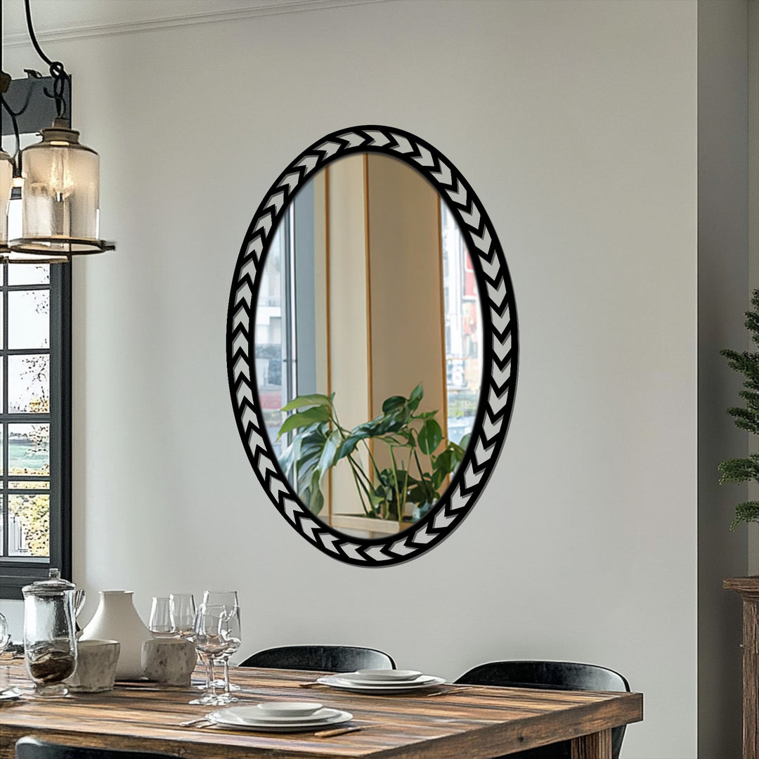 Defined by its negative space, the geometric chevron floor mirror features striking metal artwork with a repeating arrowhead design.