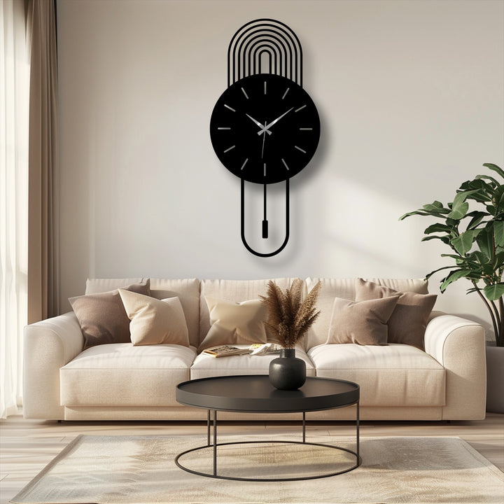 Organic forms dominate the decorative metal art of this modern arc wall clock, a pendulum design that suggests growth and movement.