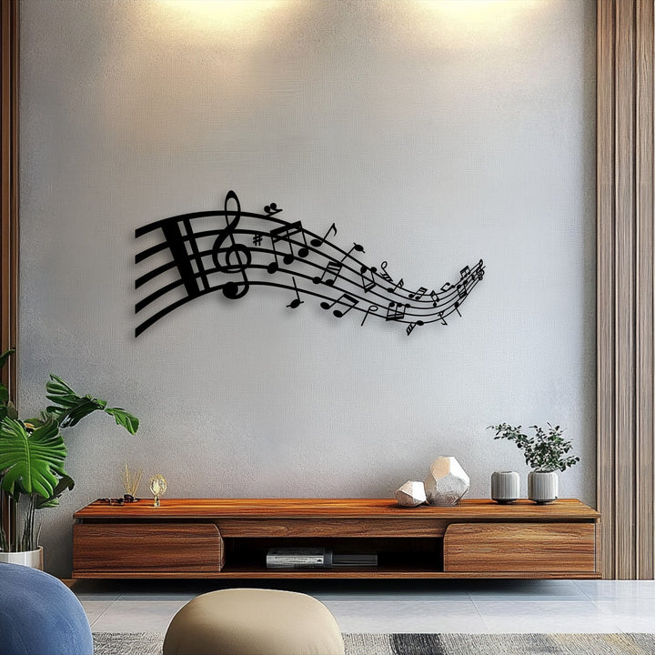 A textured light grey wall, subtly illuminated from above, beautifully showcases the elegant flowing musical notes metal art for wall.