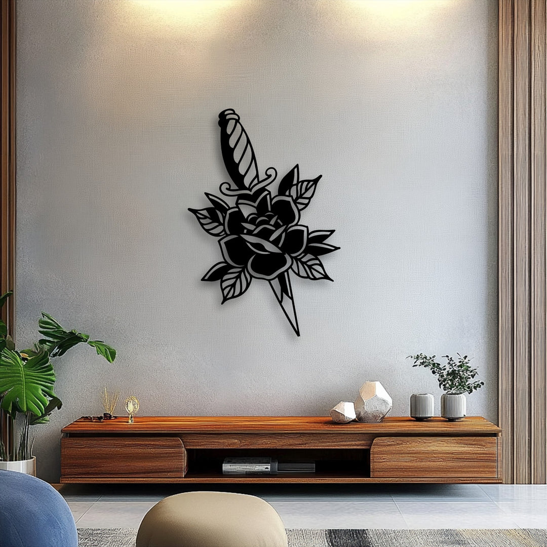The bold black rose and dagger silhouette, a piece of decorative metal art, stands out as the focal point on a textured light grey wall.