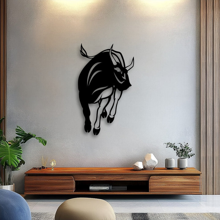 The visual rhythm of this powerful charging bull silhouette metal art for wall pulsates with dynamic energy against a textured neutral background.