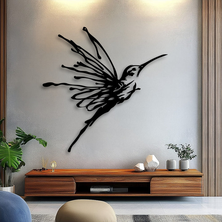 The abstract quality of this flying hummingbird metal artwork is depicted through its striking, fluid black lines creating an elegant bird design.