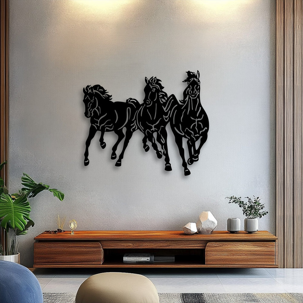 The striking silhouette of three dynamic, galloping horses crafted from black metal art for wall dramatically stands out against the textured wall.