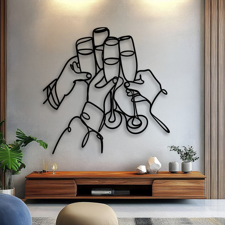 Muted beige textured wall showcasing a striking black celebration line art unique metal wall art of hands toasting.