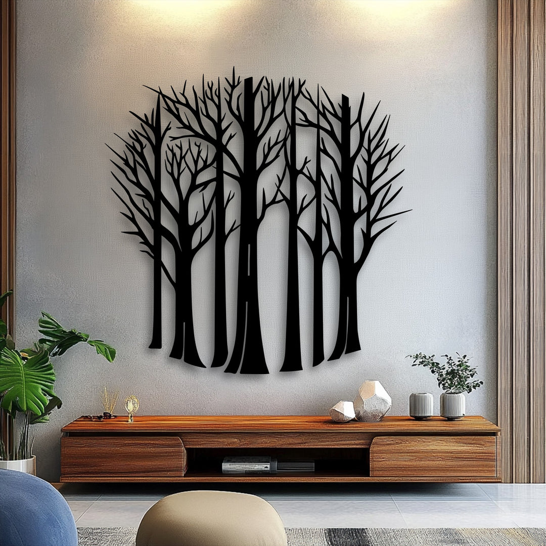 The textured light gray wall with subtle warm lighting above provides a perfect backdrop for the elegant bare forest trees metal wall decor.