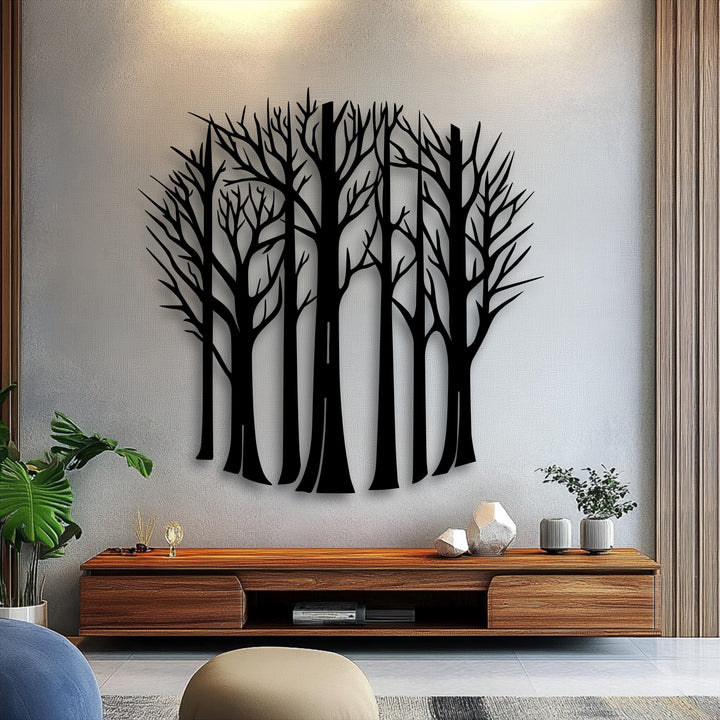 The textured light gray wall with subtle warm lighting above provides a perfect backdrop for the elegant bare forest trees metal wall decor.