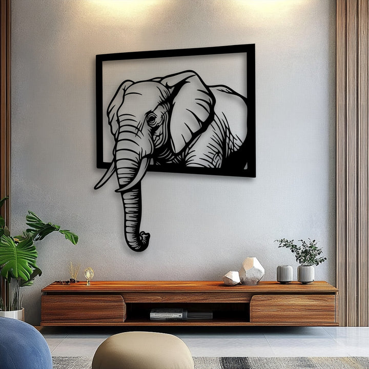 The negative space of the bright wall highlights the striking silhouette of the emerging elephant frame 3D effect metal wall decor, creating depth.