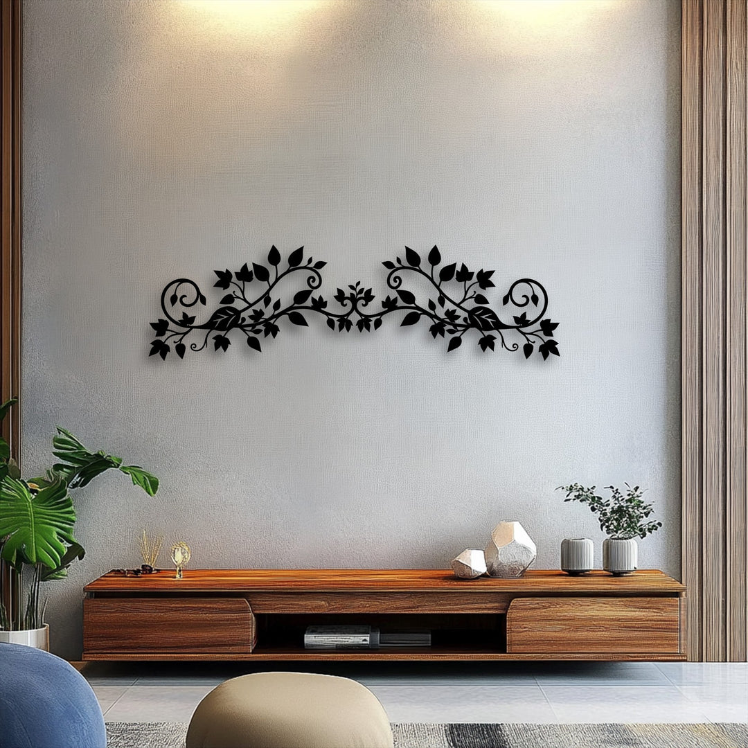 The deep black of the elegant floral vine unique metal wall art provides a stunning color contrast against the light, textured wall surface.