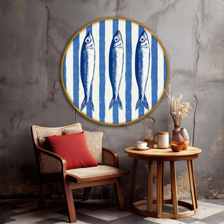 Three illustrated fish take center stage in this canvas painting, a round nautical striped wall art piece perfect for adding a coastal touch.