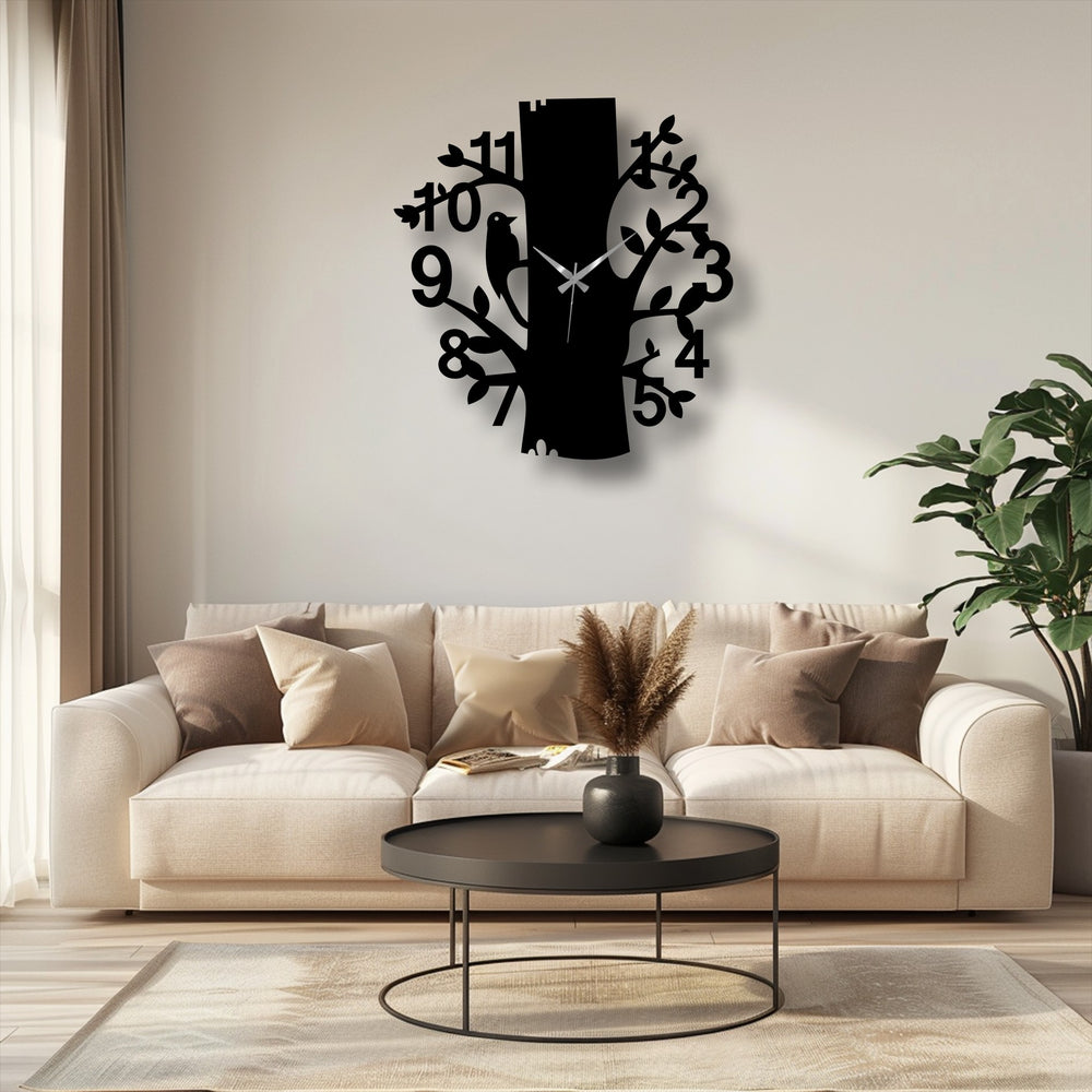 Depth and layers create a striking focal point in this metal wall decor clock, with a stylized tree and bird design adding dimension.