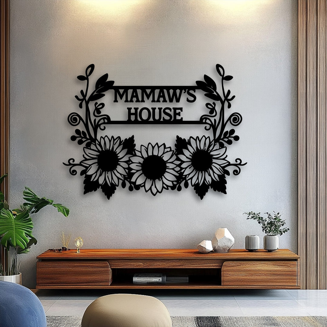 The abstract silhouette of black decorative metal art forms a personalized sunflower family name sign with intricate floral and leaf patterns.
