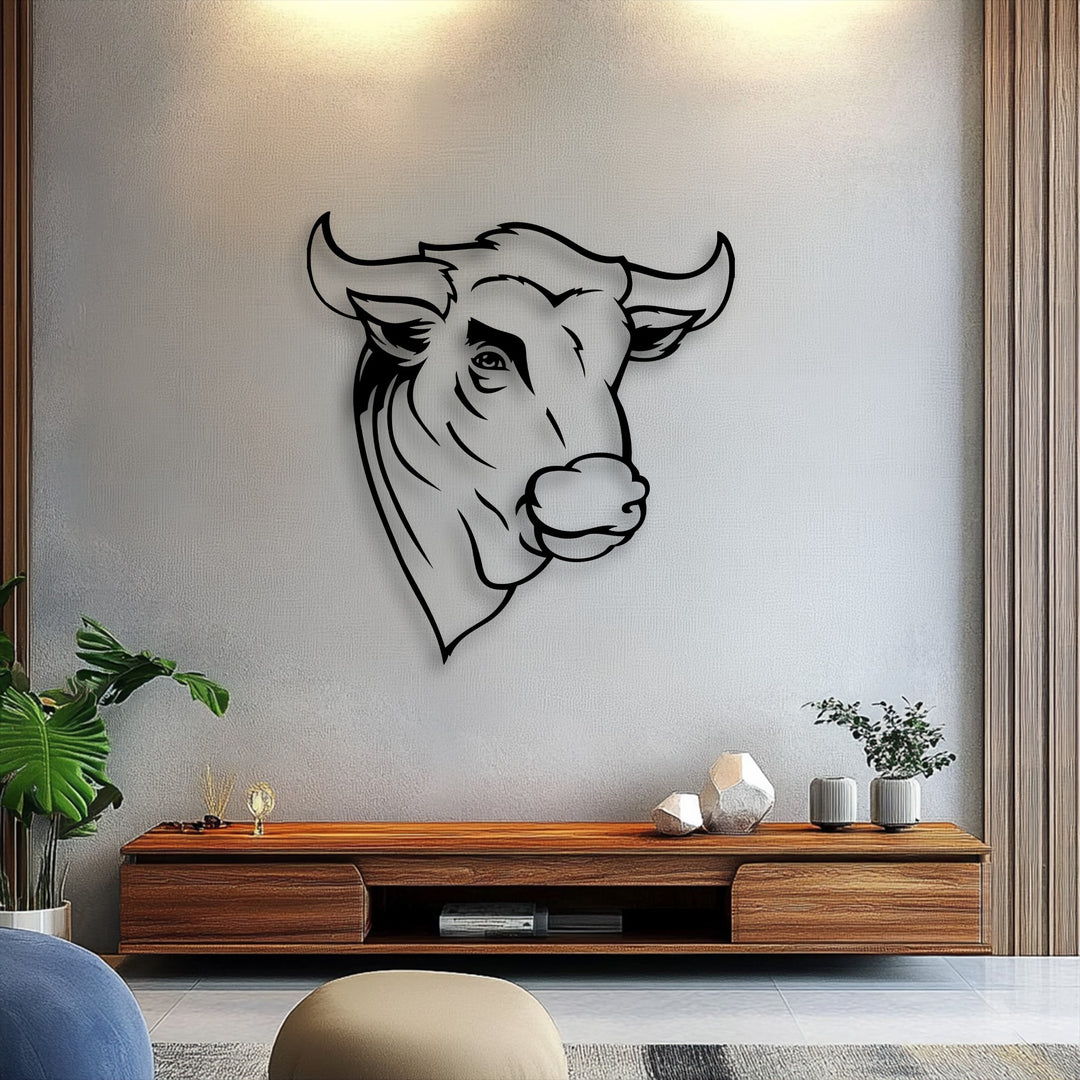 Plush beige seating and a subtly textured rug enhance the modern minimal line bull decorative metal art.