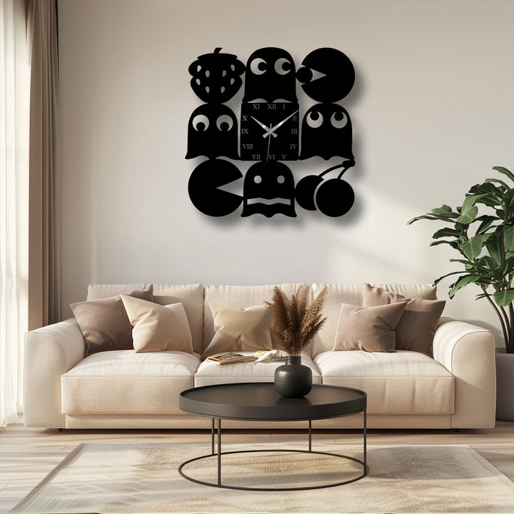 A unique metal wall art clock displays a retro arcade-inspired design with playful black Pac-Man characters and fruits.